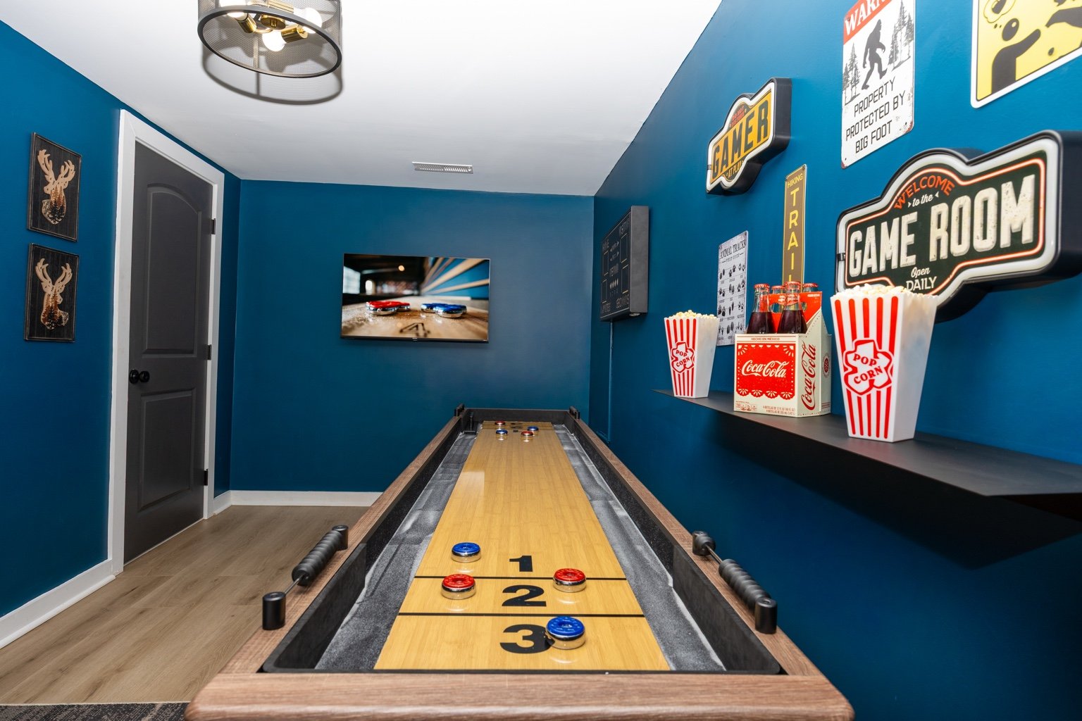 Vacation rental game room with shuffleboard photographed by Pic Me STR Photography